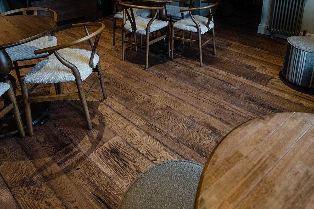 Distressed random width flooring with a in a restaurant.
