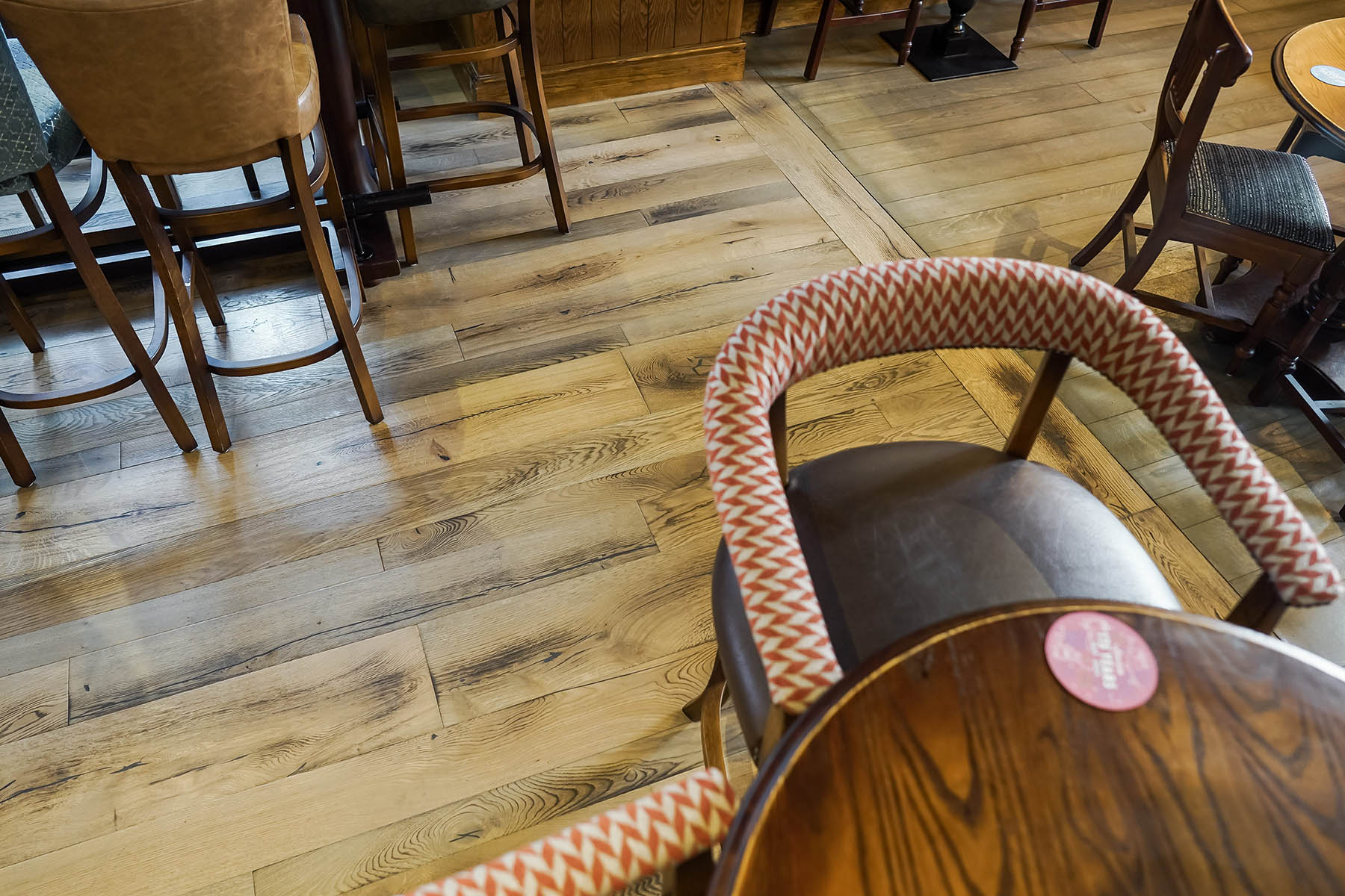 Distressed and brushed oak floors enhancing pub interiors.