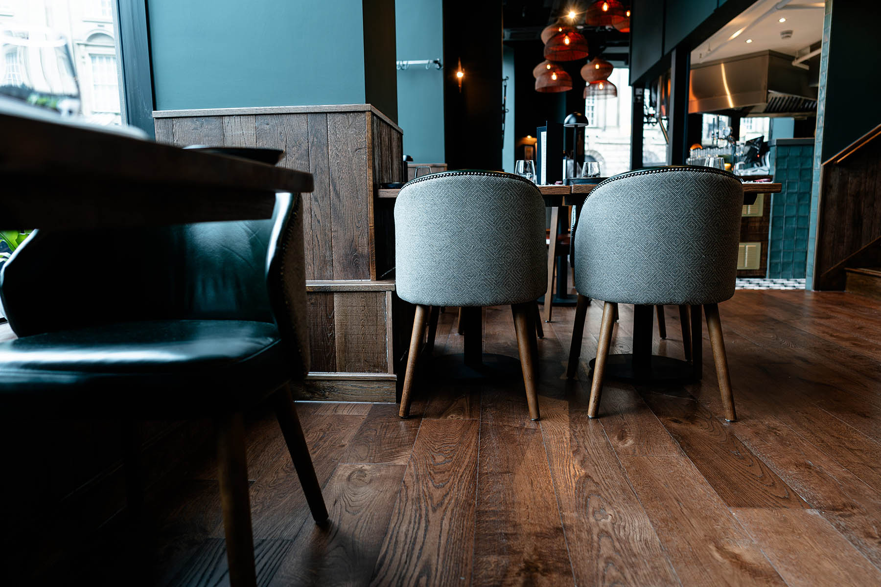 Rustic engineered oak floor complementing tan leather seating
