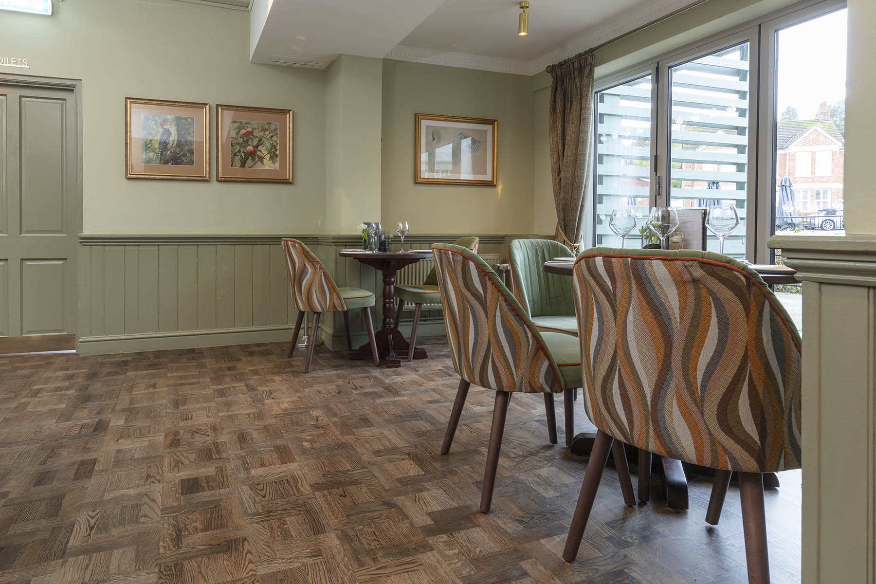 Elegant dining space at The Swan Pub, Milton Keynes, featuring JackEvie’s Foxtrot Park parquet basketweave flooring.