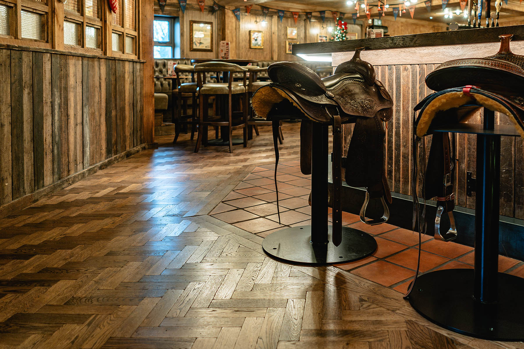 Rich-toned herringbone wood complementing rustic design elements.