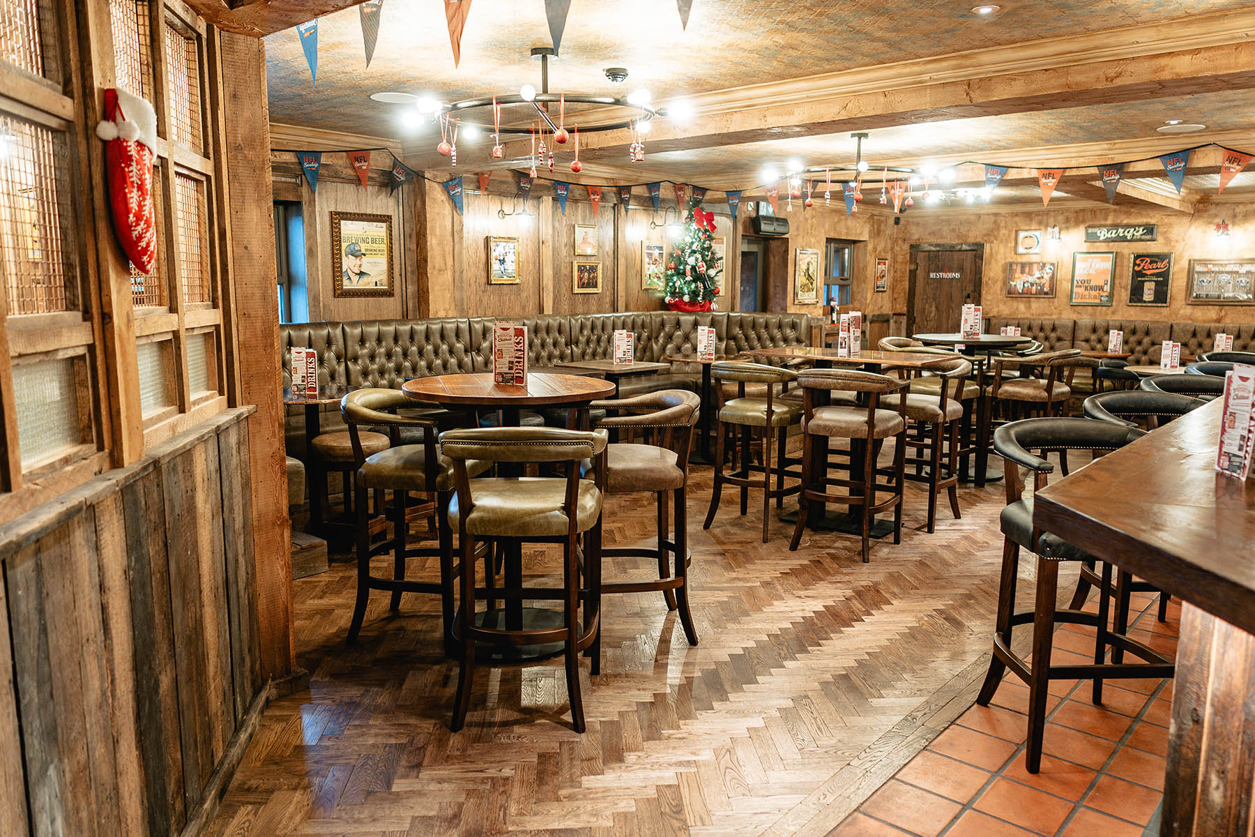 Seamless integration of herringbone and wide plank flooring in Hickory’s venue.
