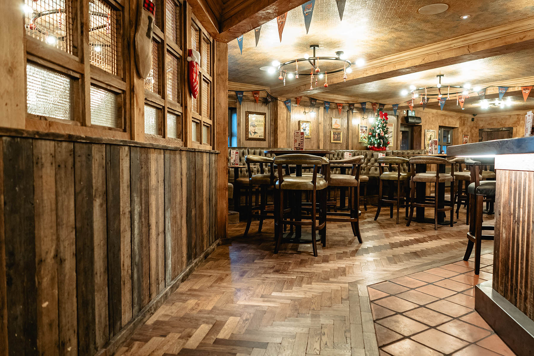 Striking herringbone flooring pairing with American BBQ-inspired interiors.
