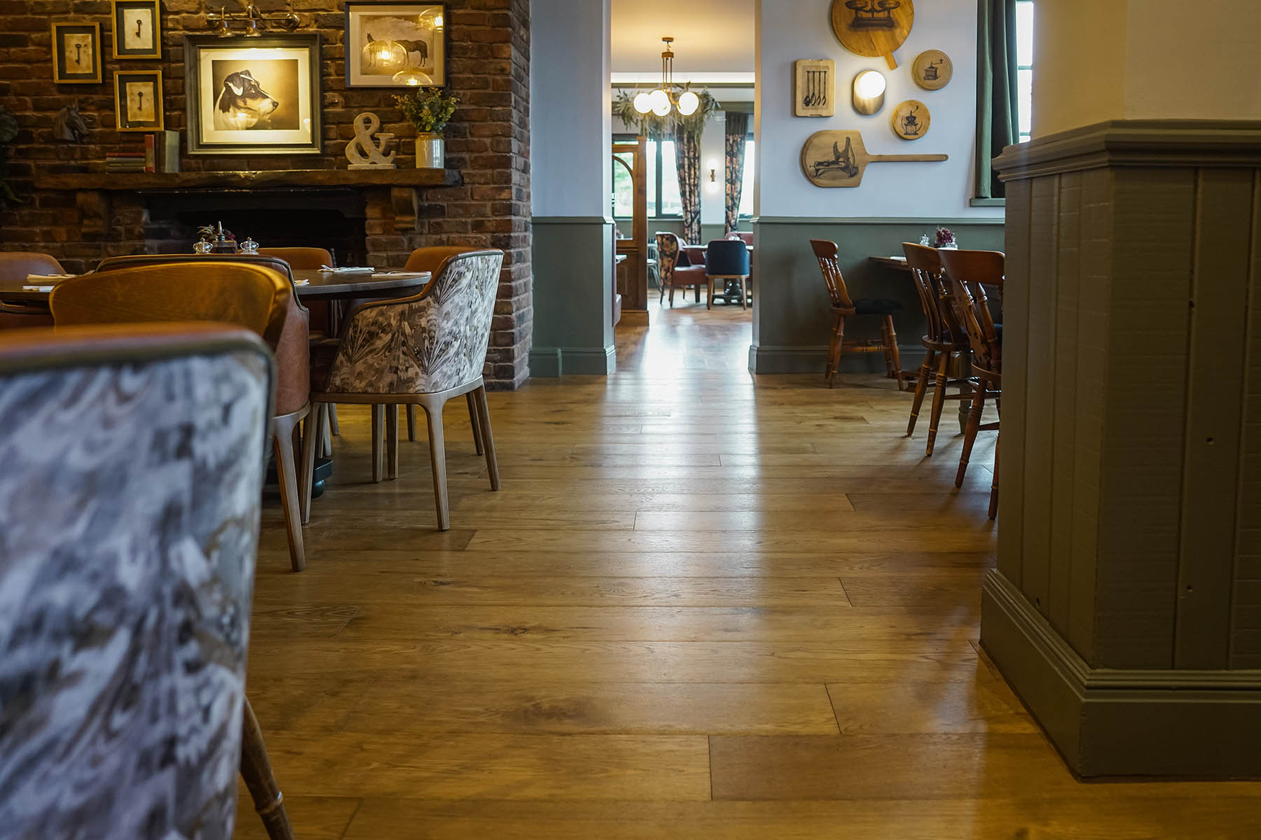 Rustic oak flooring in a dining space, enhancing the warm and inviting atmosphere with natural wood tones.