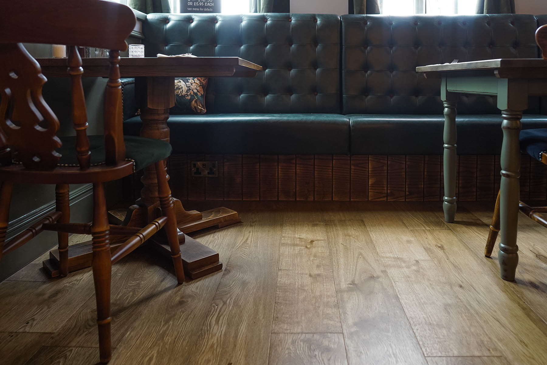 Inviting seating area at The Hornsmill in Chester with Anstey Lane plank flooring featuring warm oak tones from JackEvie's Alton Collection.