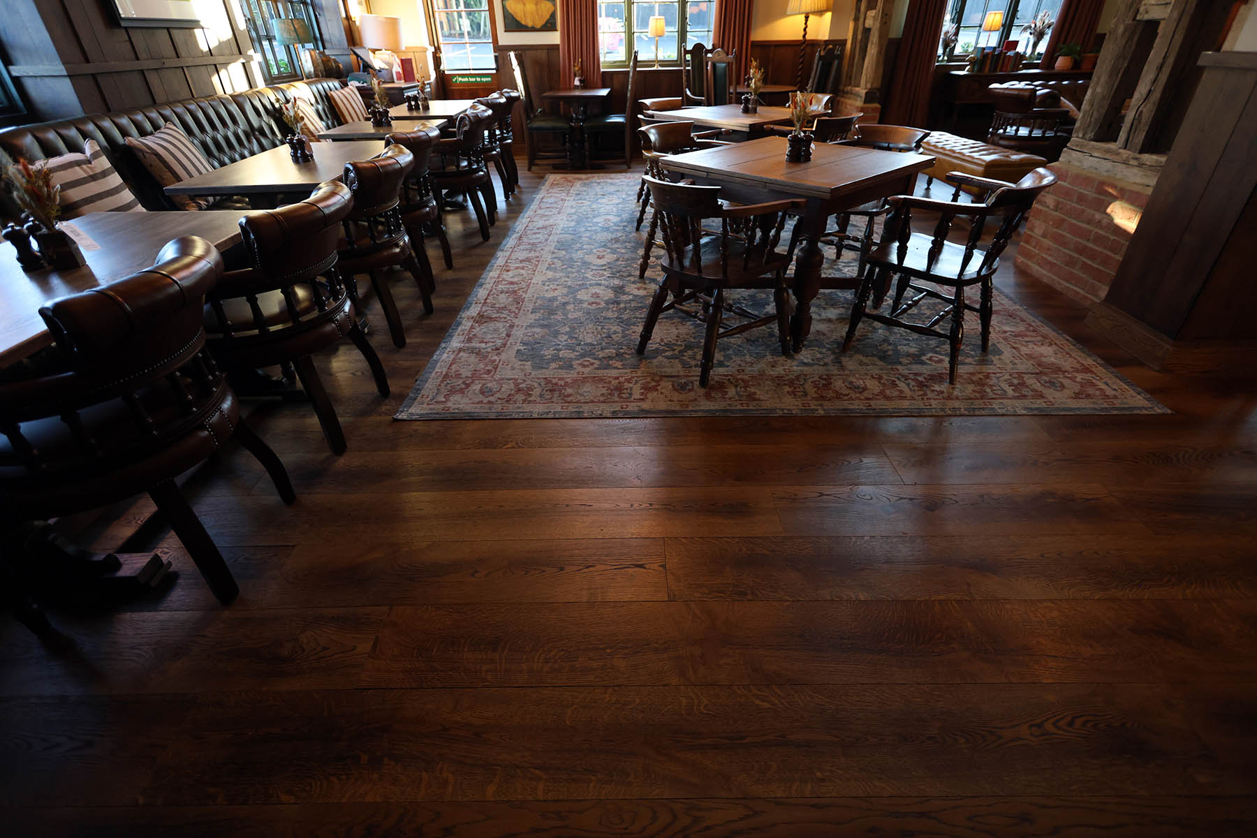 Warm-toned oak plank flooring enhancing pub aesthetics.