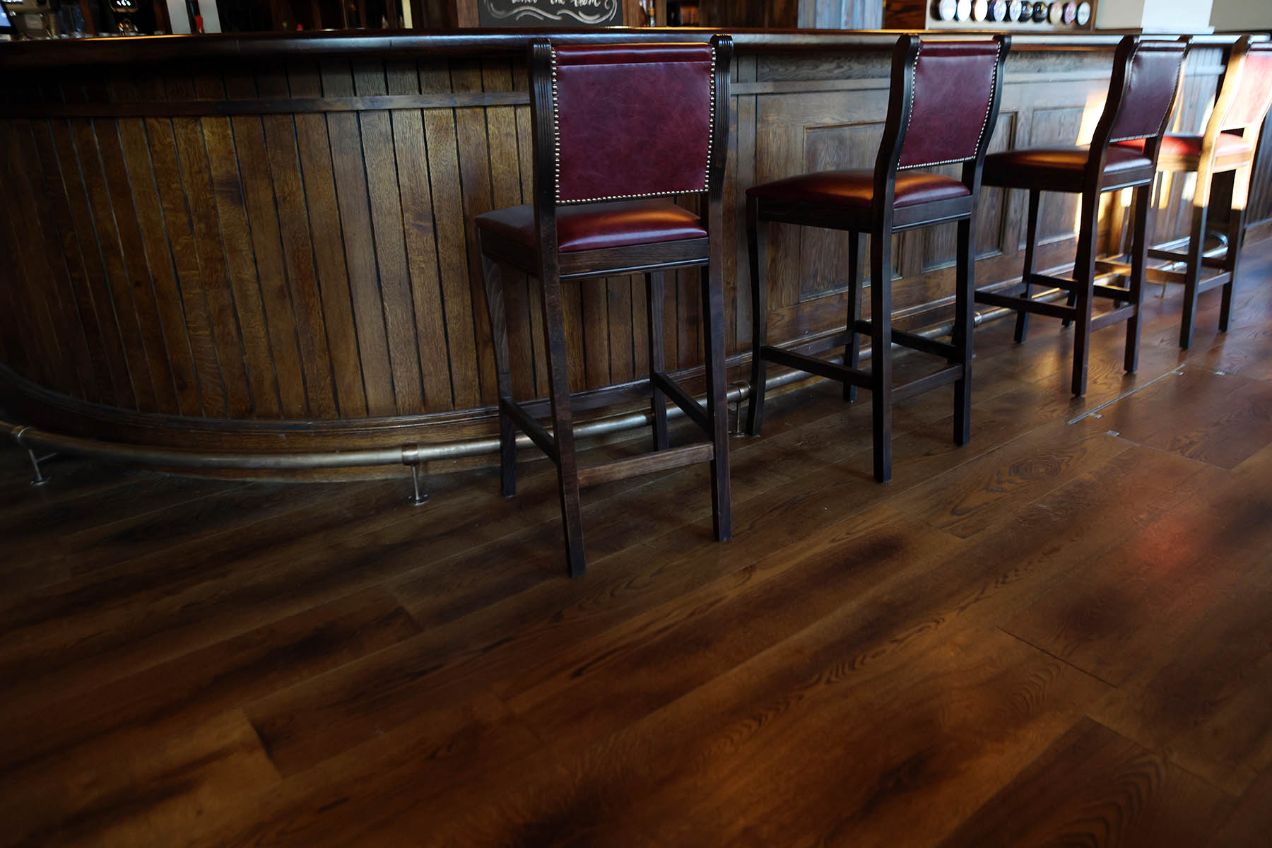 Striking herringbone flooring pairing with American BBQ-inspired interiors.