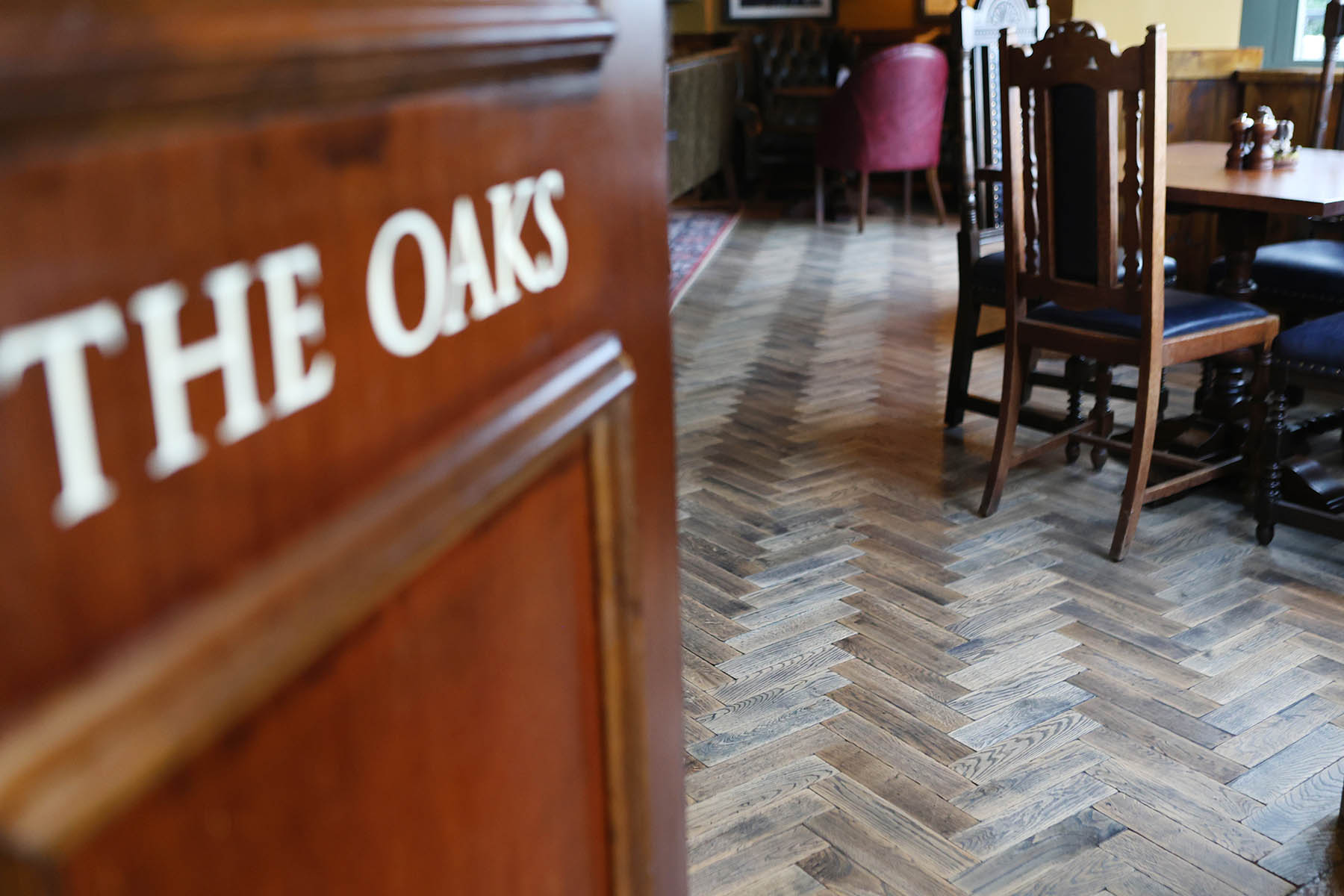 Traditional herringbone wooden flooring in a hospitality setting.