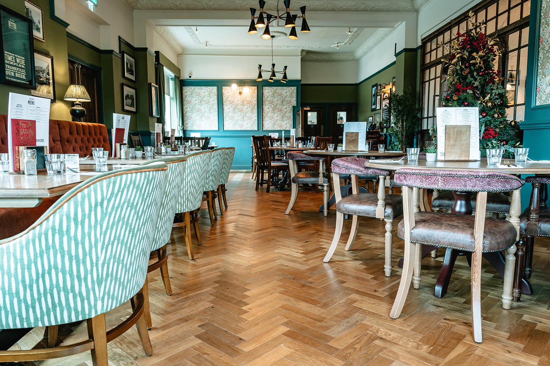 Medium oak herringbone flooring adding elegance to a Victorian-inspired design.