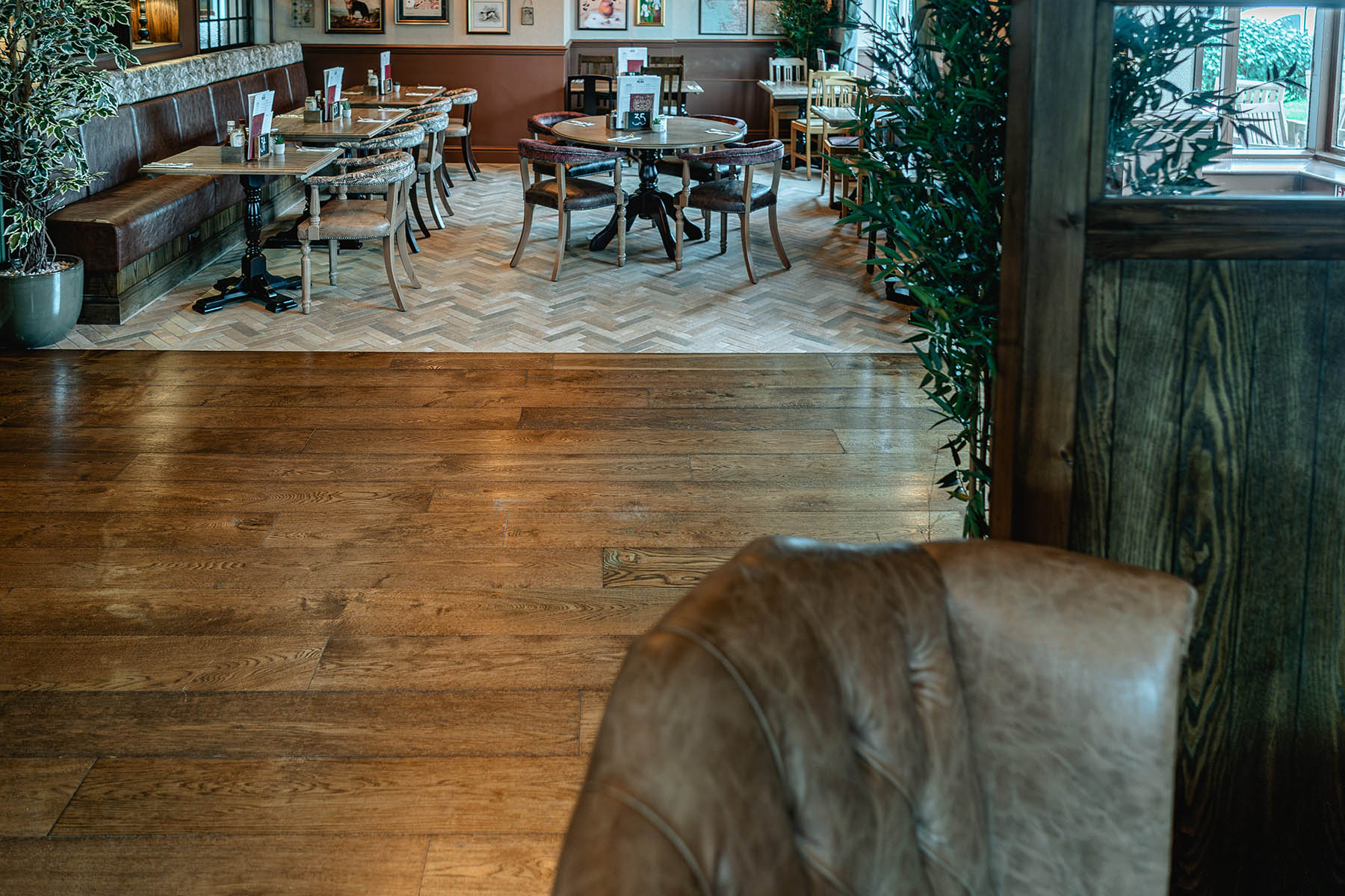 Brushed, worn, and dented oak planks paired with eclectic seating styles.