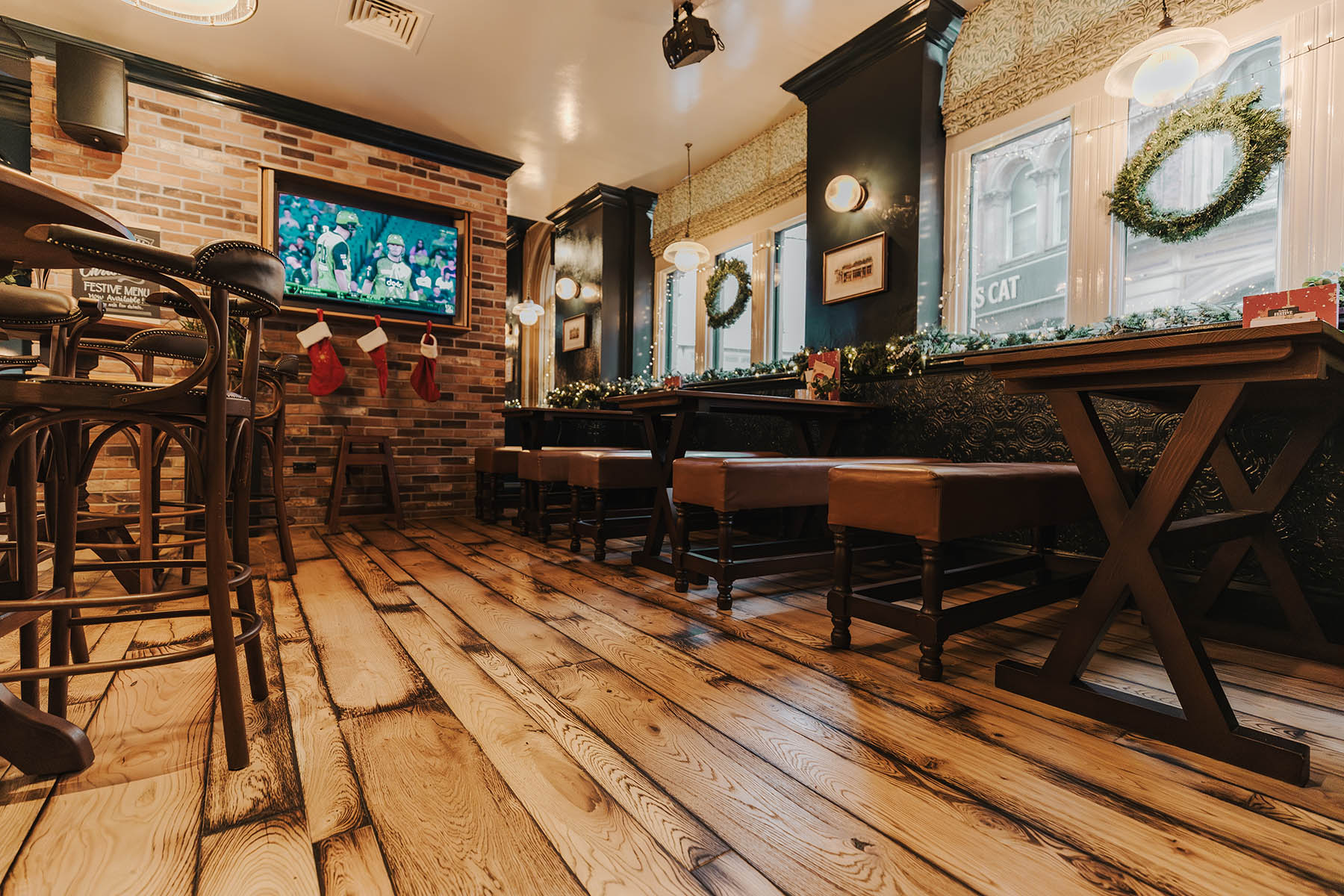 Rustic oak flooring with brushed, worn, and dented surface at The Griffin pub.
