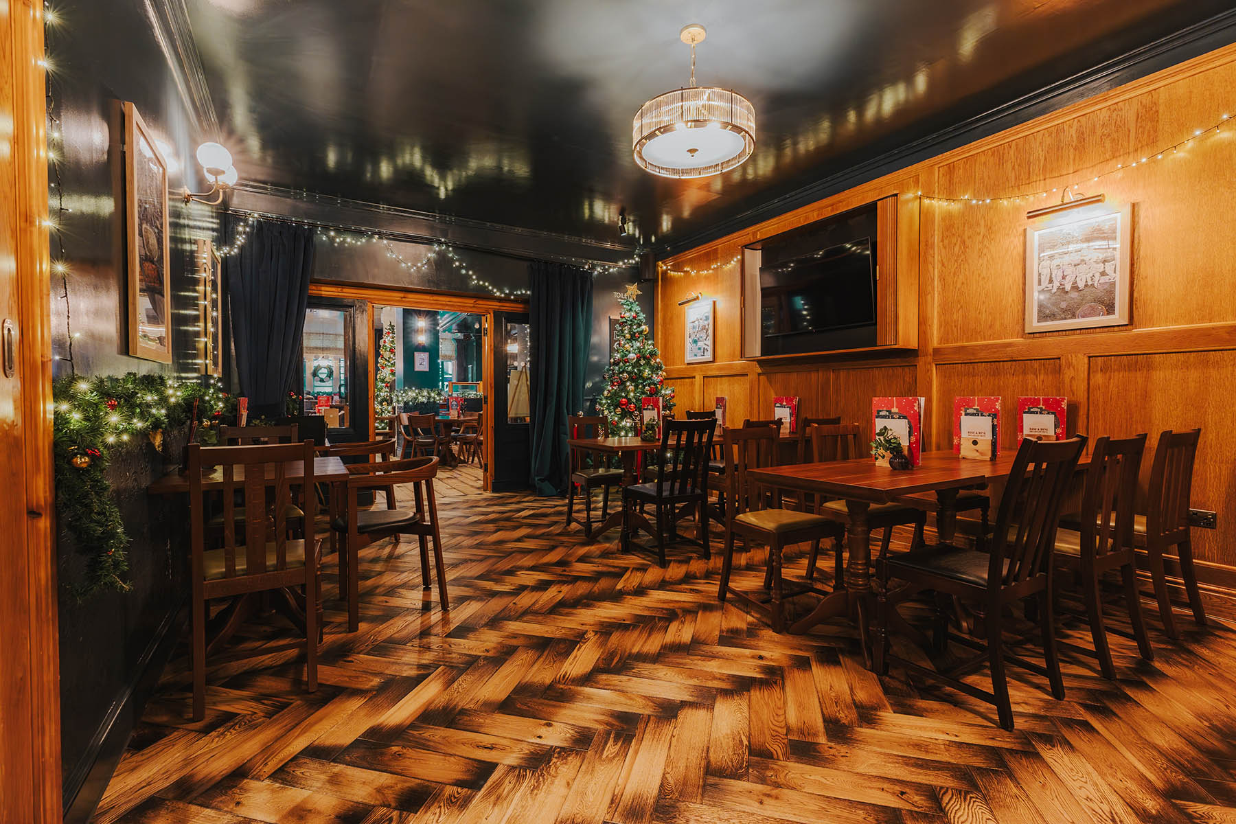 Rustic oak flooring under warm lighting and vintage-inspired decor at The Griffin.