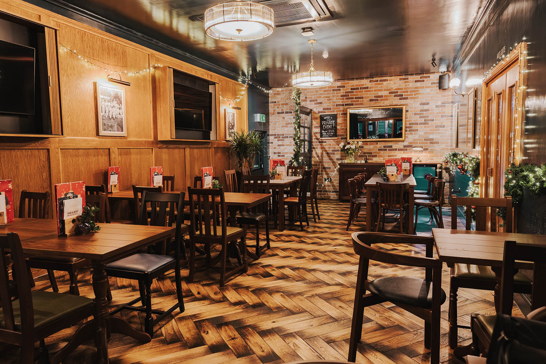 Engineered herringbone wood flooring with burnt edges in The Griffin, Leeds.