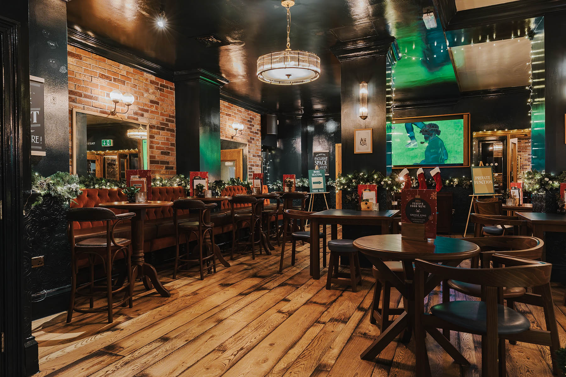 Lowfield Lane plank flooring paired with tufted seating and deep green walls.
