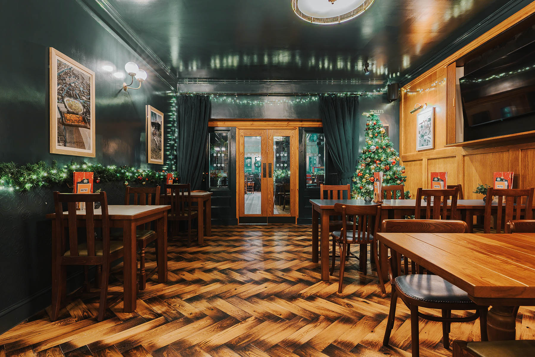 Engineered herringbone wood flooring with burnt edges in The Griffin, Leeds.